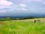 Clouds over grassland terrain